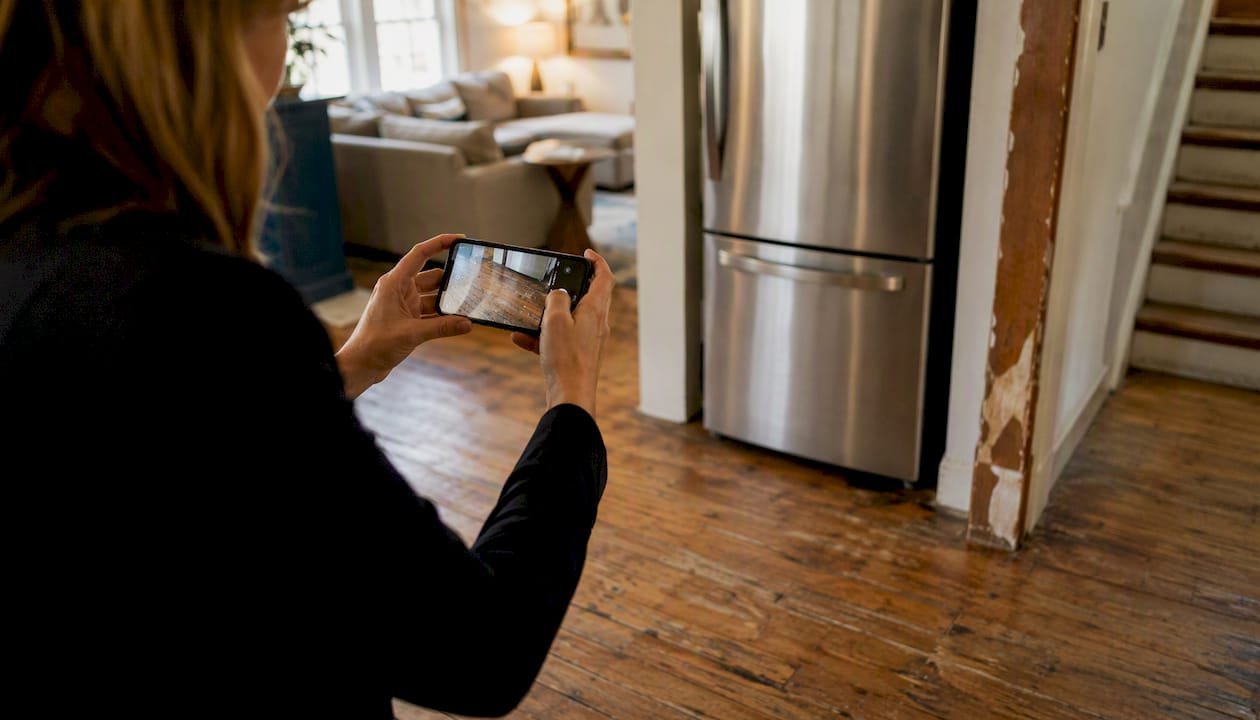 Hands taking photos of home condition details